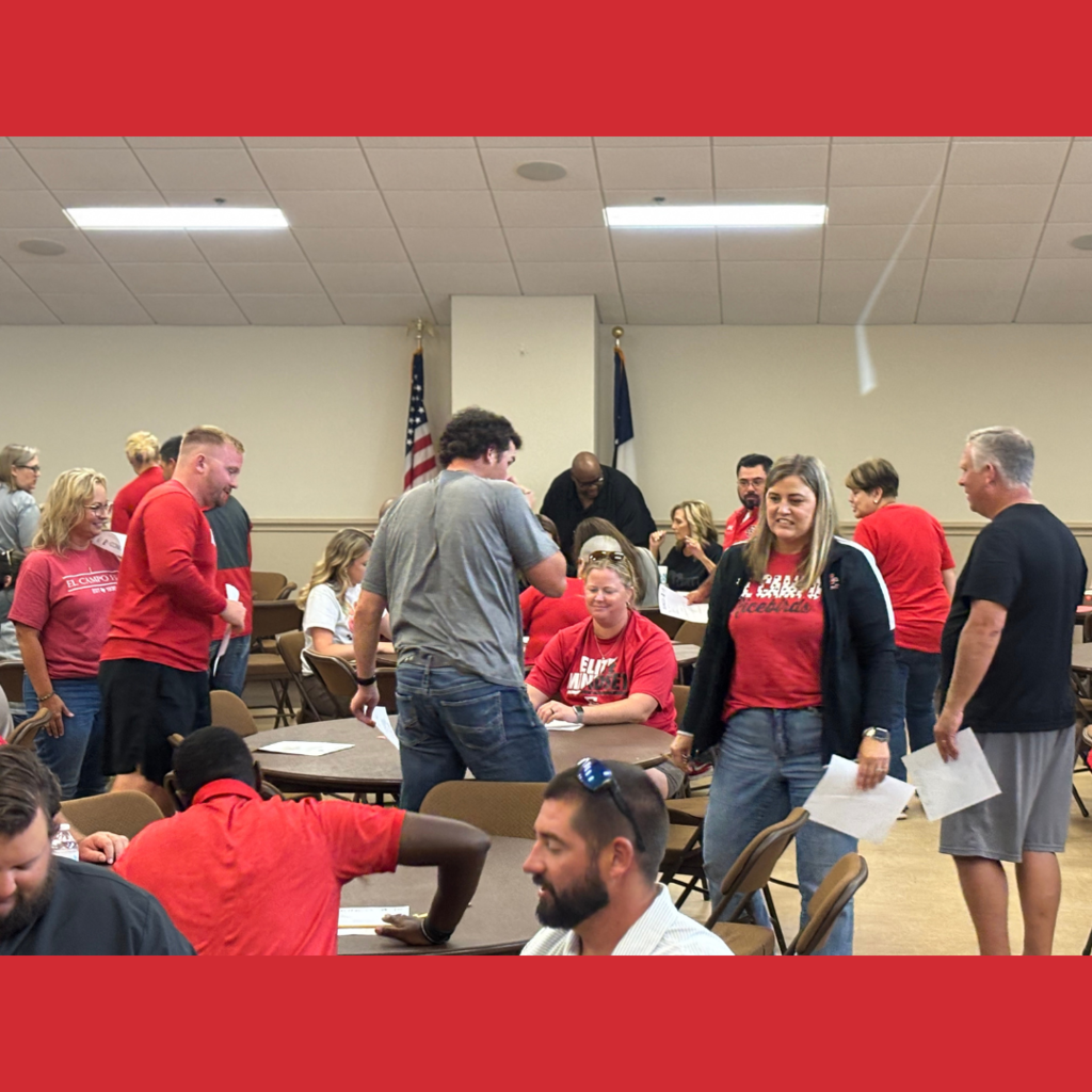 adults at tables and around a room playing bunco
