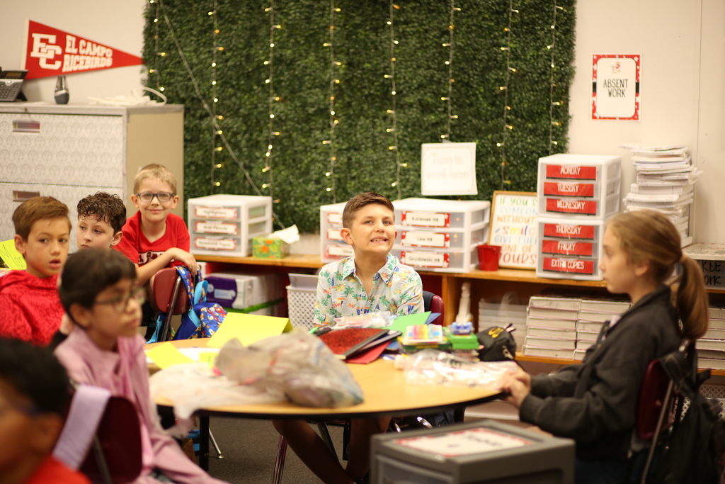excited kids at table in classroom