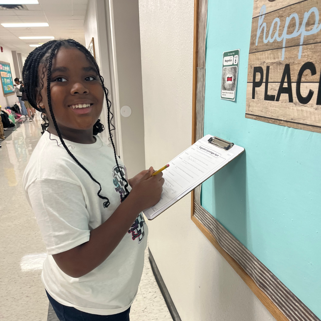 kids with clipboards standing while working