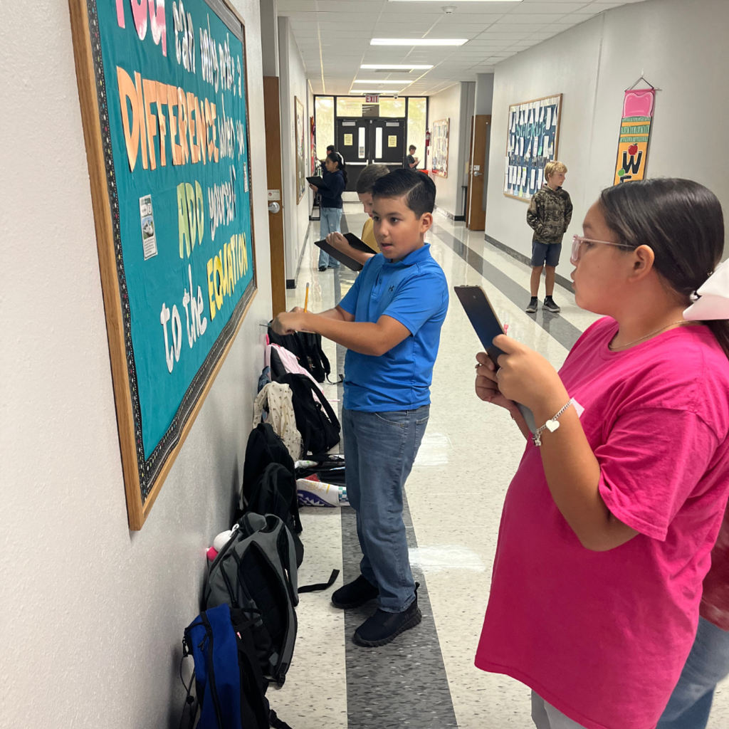 kids with clipboards standing while working