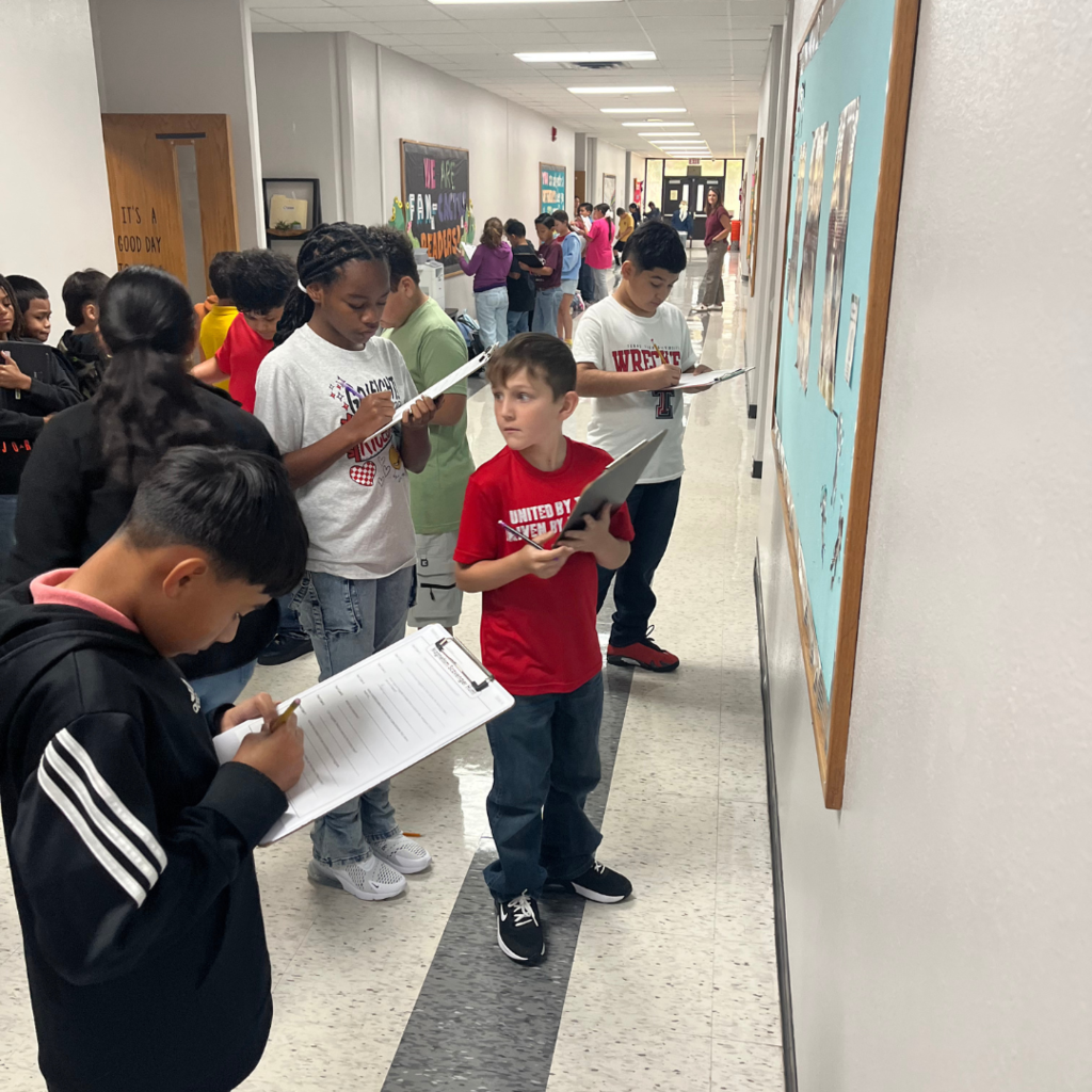 kids with clipboards standing while working