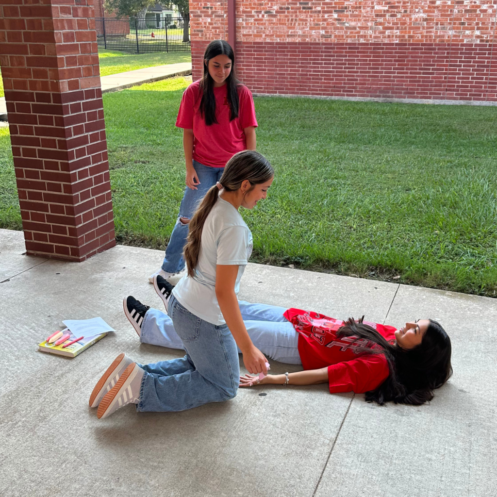 students learning terms with sidewalk chalk and lifesize drawings 