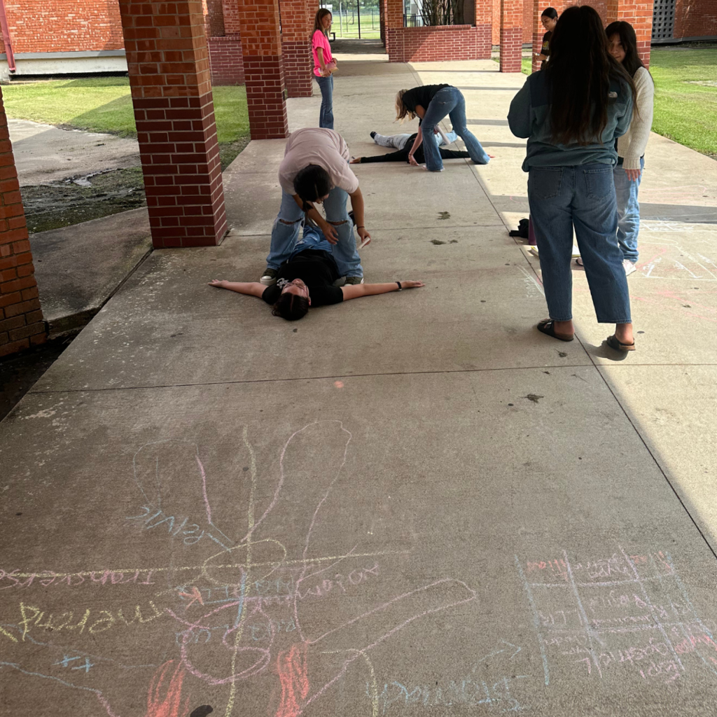 students learning terms with sidewalk chalk and lifesize drawings