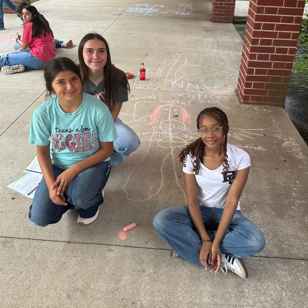 students learning terms with sidewalk chalk and lifesize drawings 