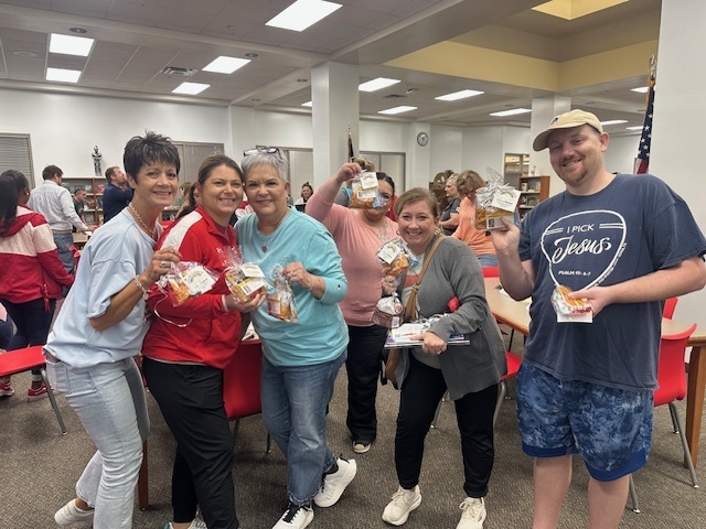 adults showing off their goody bags