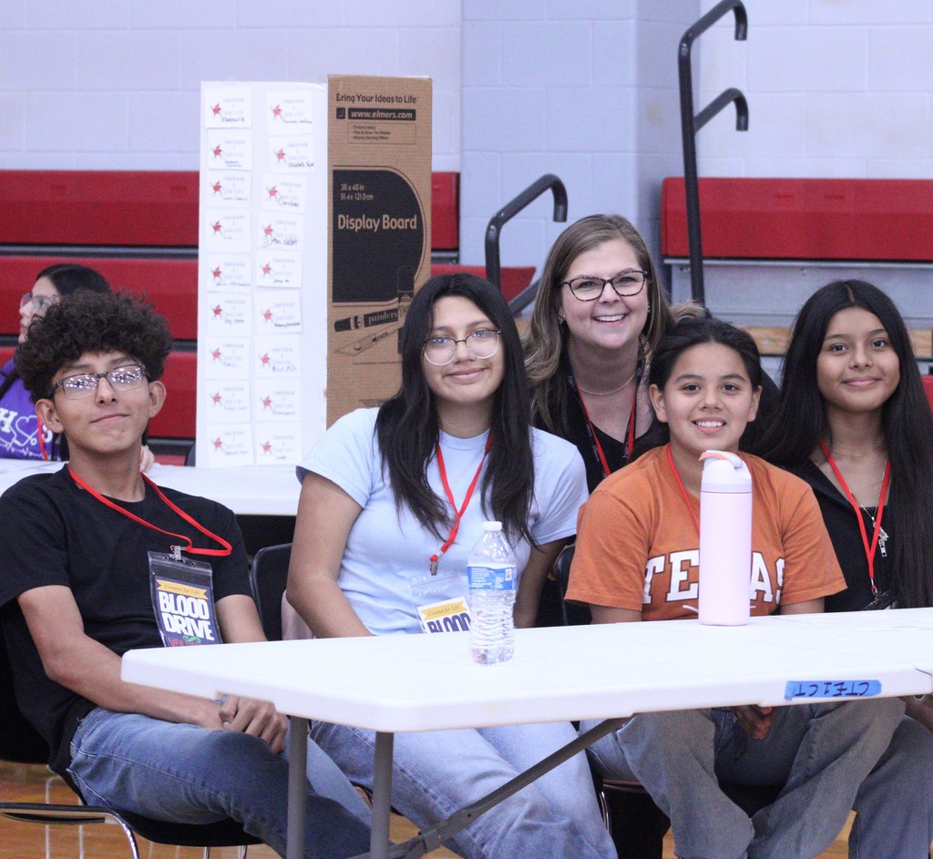 student volunteers with teacher