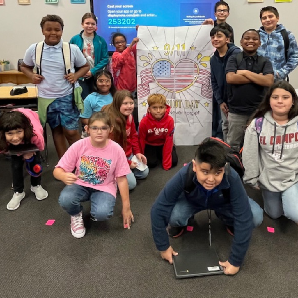 kids around a poster with a heart shaped U.S. flag