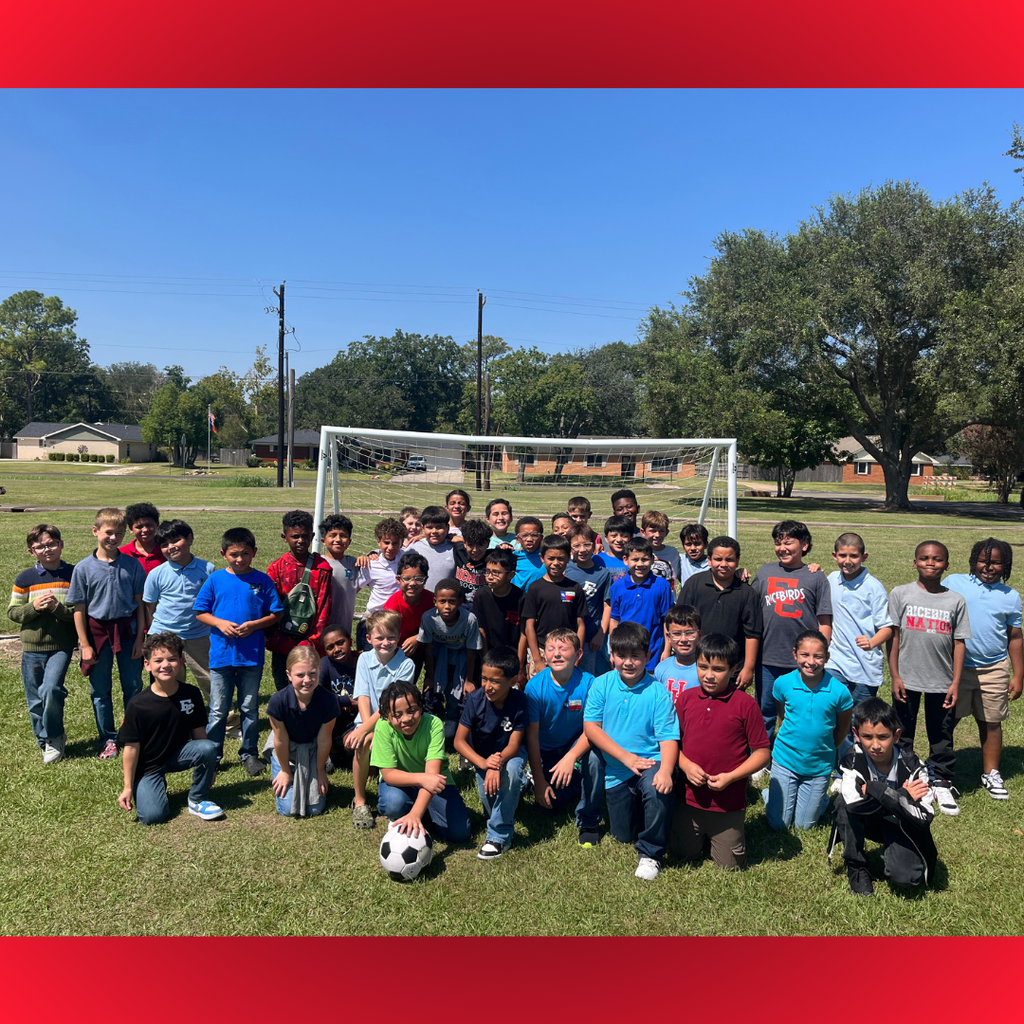 group of kids by soccer goal