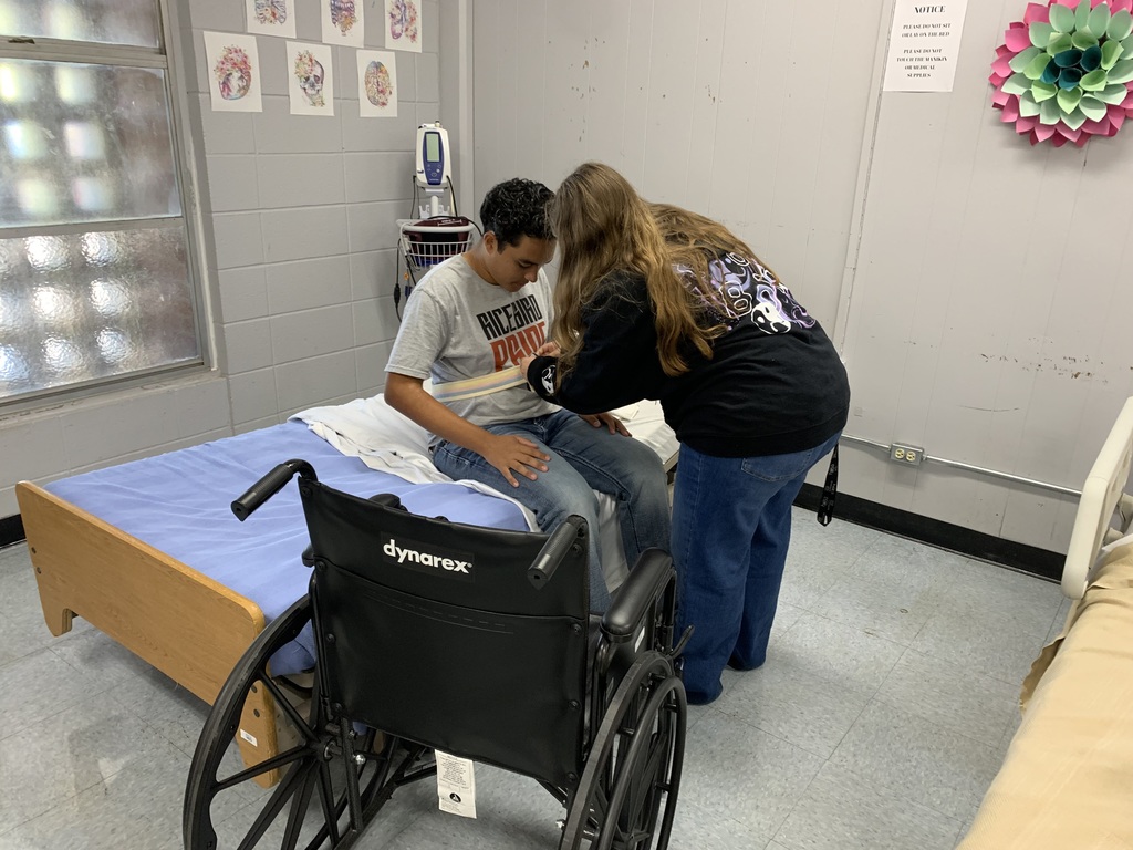 student performing their skill on their classmate acting as the patient