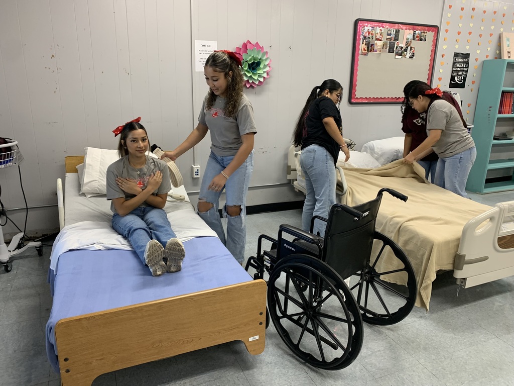 student performing their skill on their classmate acting as the patient