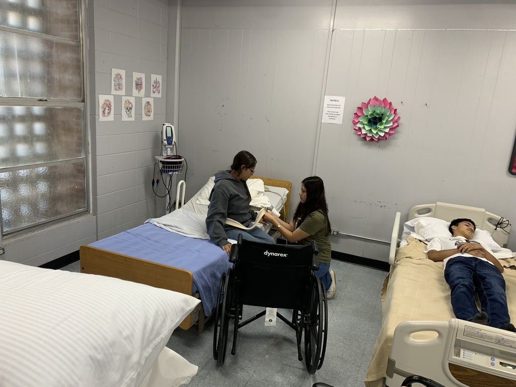 student performing their skill on their classmate acting as the patient 