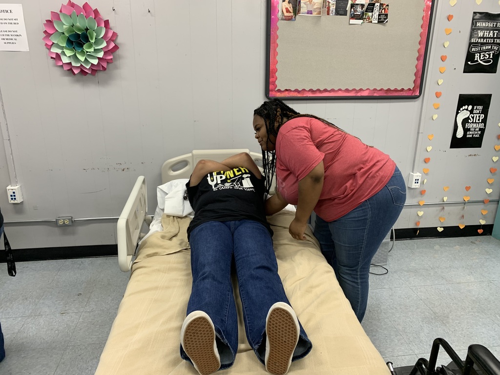 student performing their skill on their classmate acting as the patient