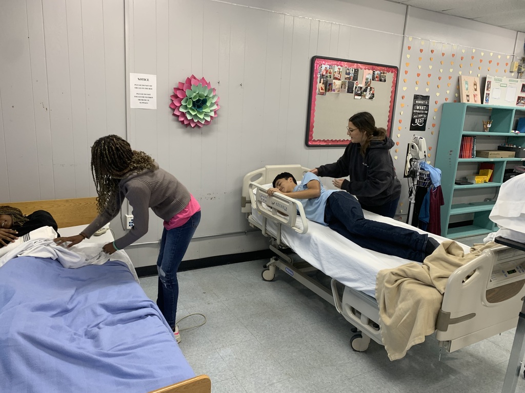 students performing their skills on their classmates acting as the patients