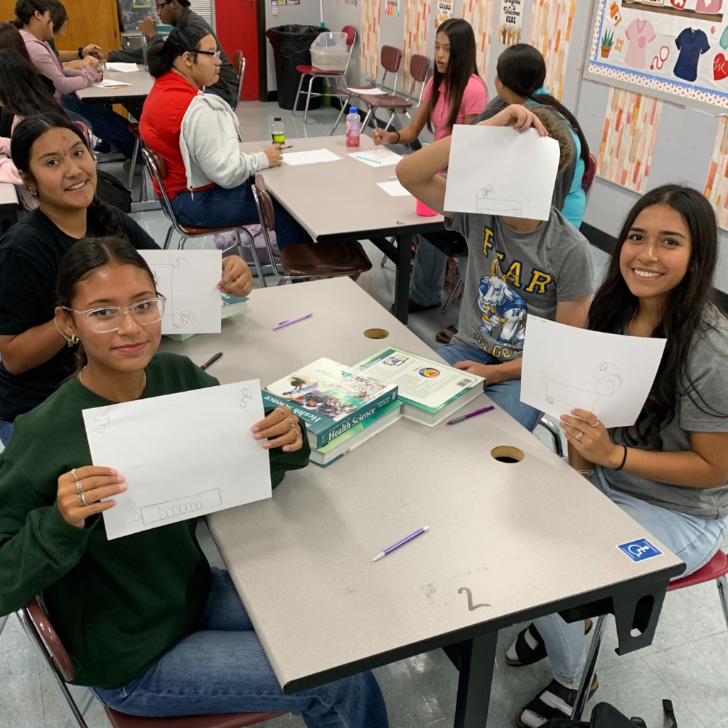 kids holding their drawing
