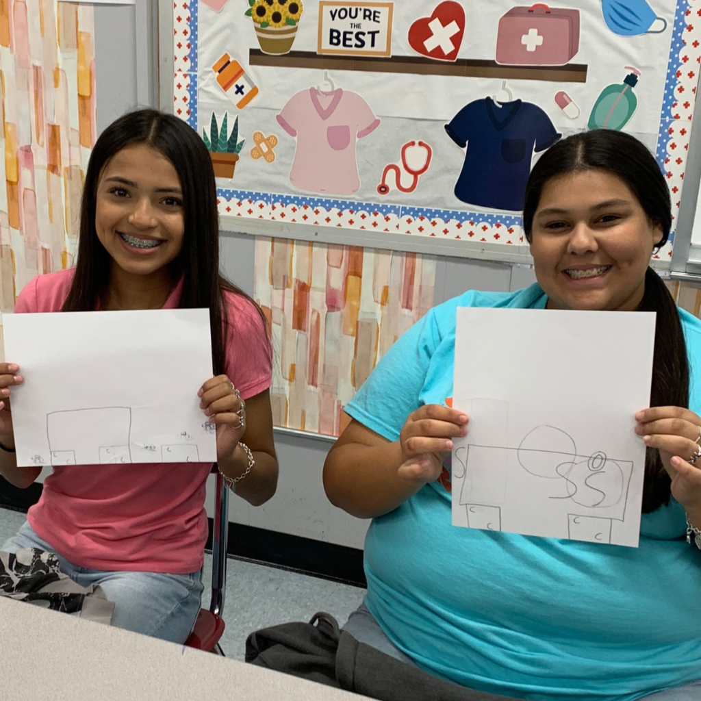 kids holding their drawing
