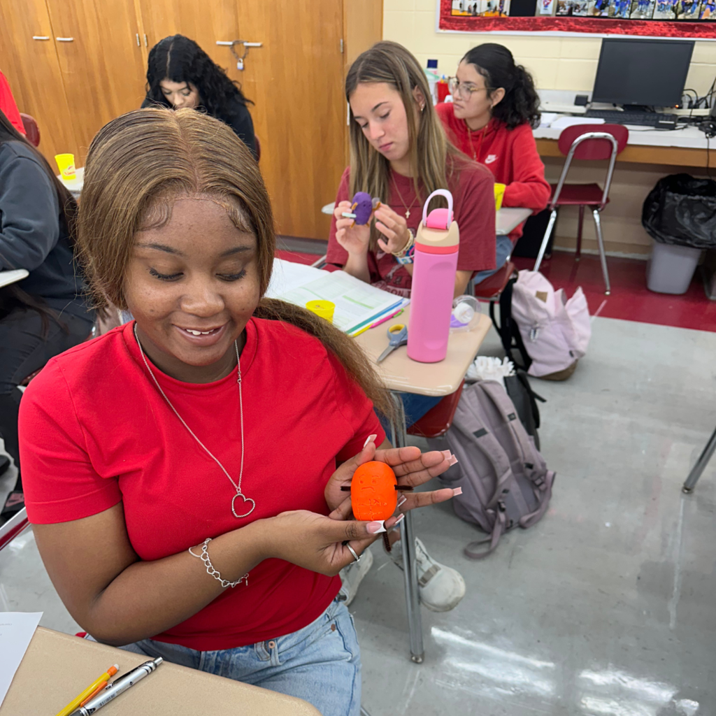 student showing off her potato