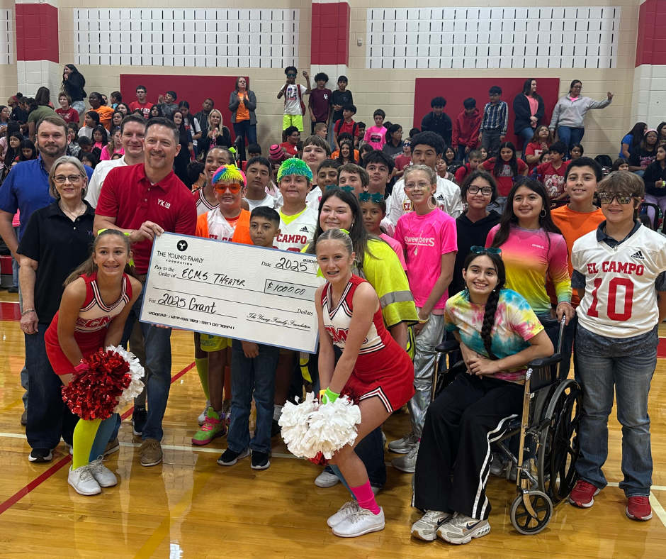 theatre students with Young family members and a big check