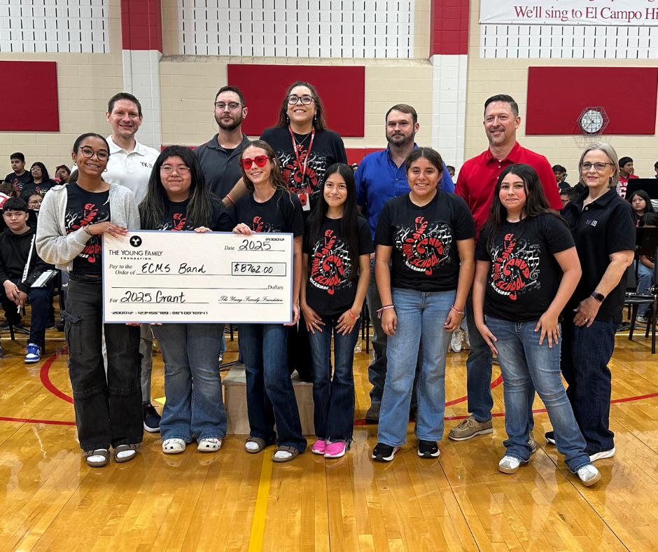 band students with Young family members and a big check