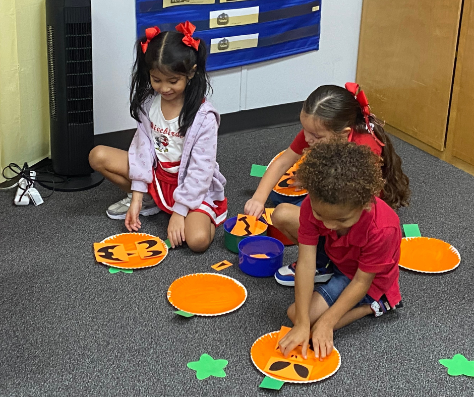 kids making paper pumpkins