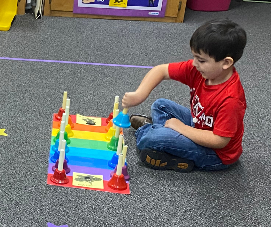 kid playing bells