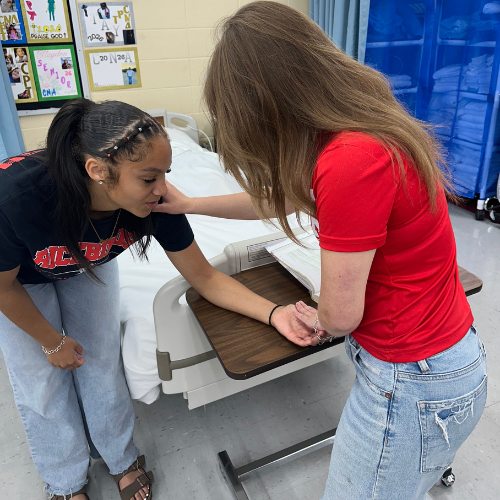 student working on range of motion with their student patient