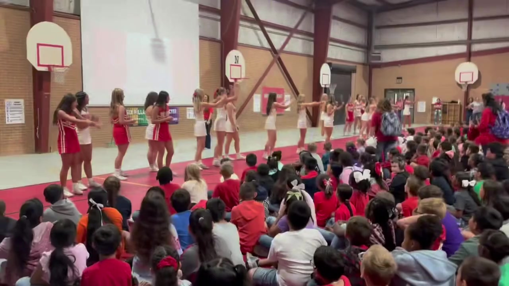 cheerleaders leading the kids in chant