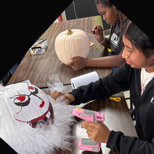 student painting a pumpkin