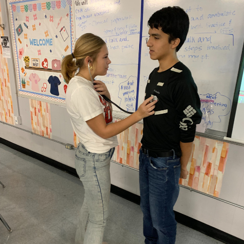 students practicing with a stethoscope