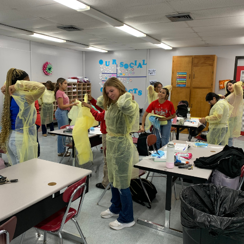 students putting on PPE