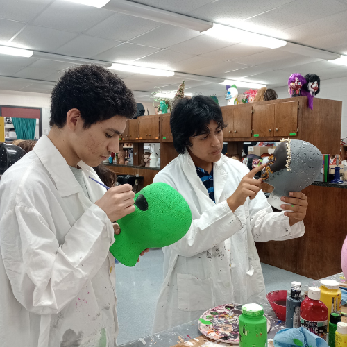 students painting mannequin faces