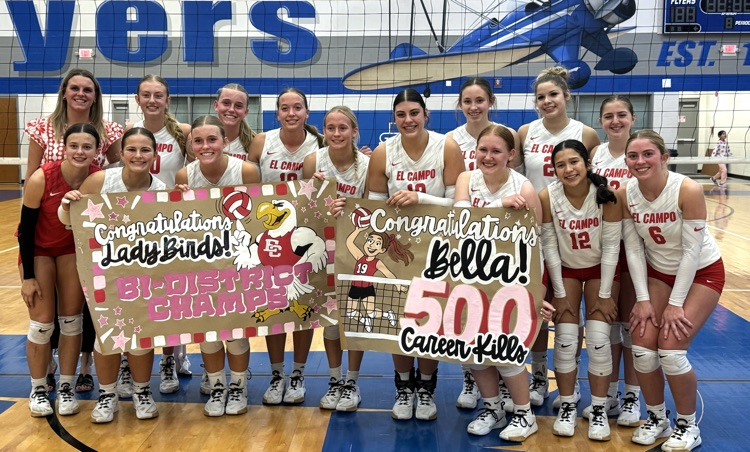 team with banner saying bi-district champs