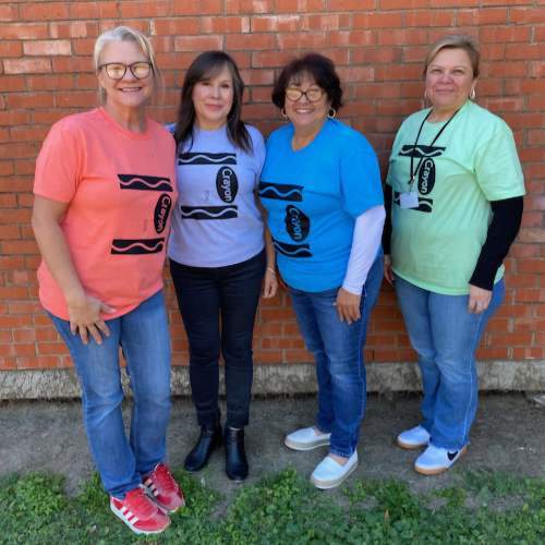 4 adults in different colored crayon shirts