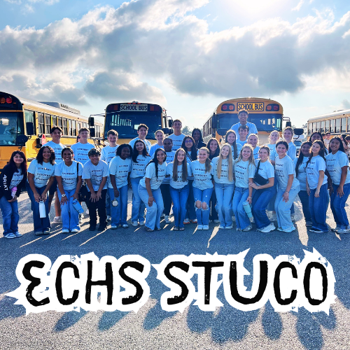 group of kids posed with school busses in the background