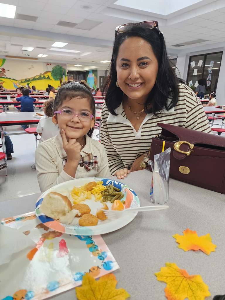 student with parent at lunch table