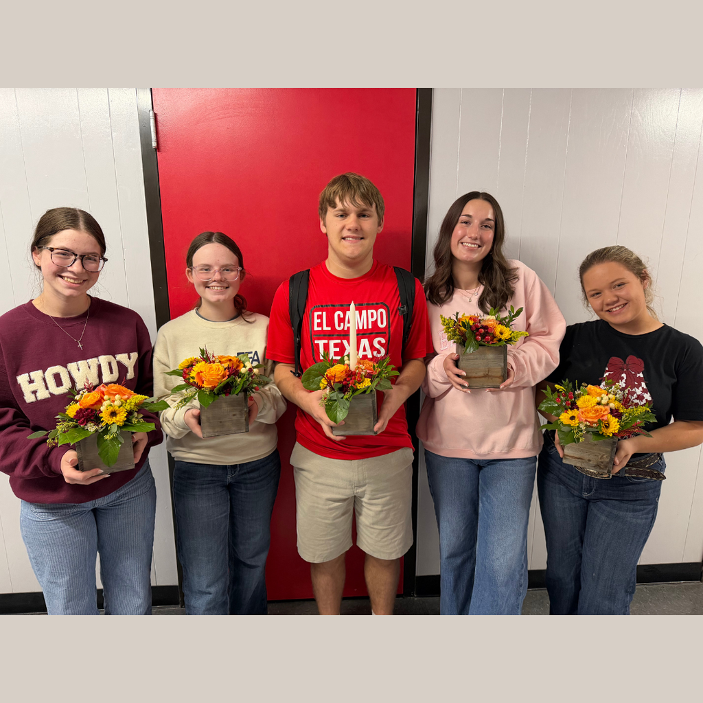 students holding their arrangement
