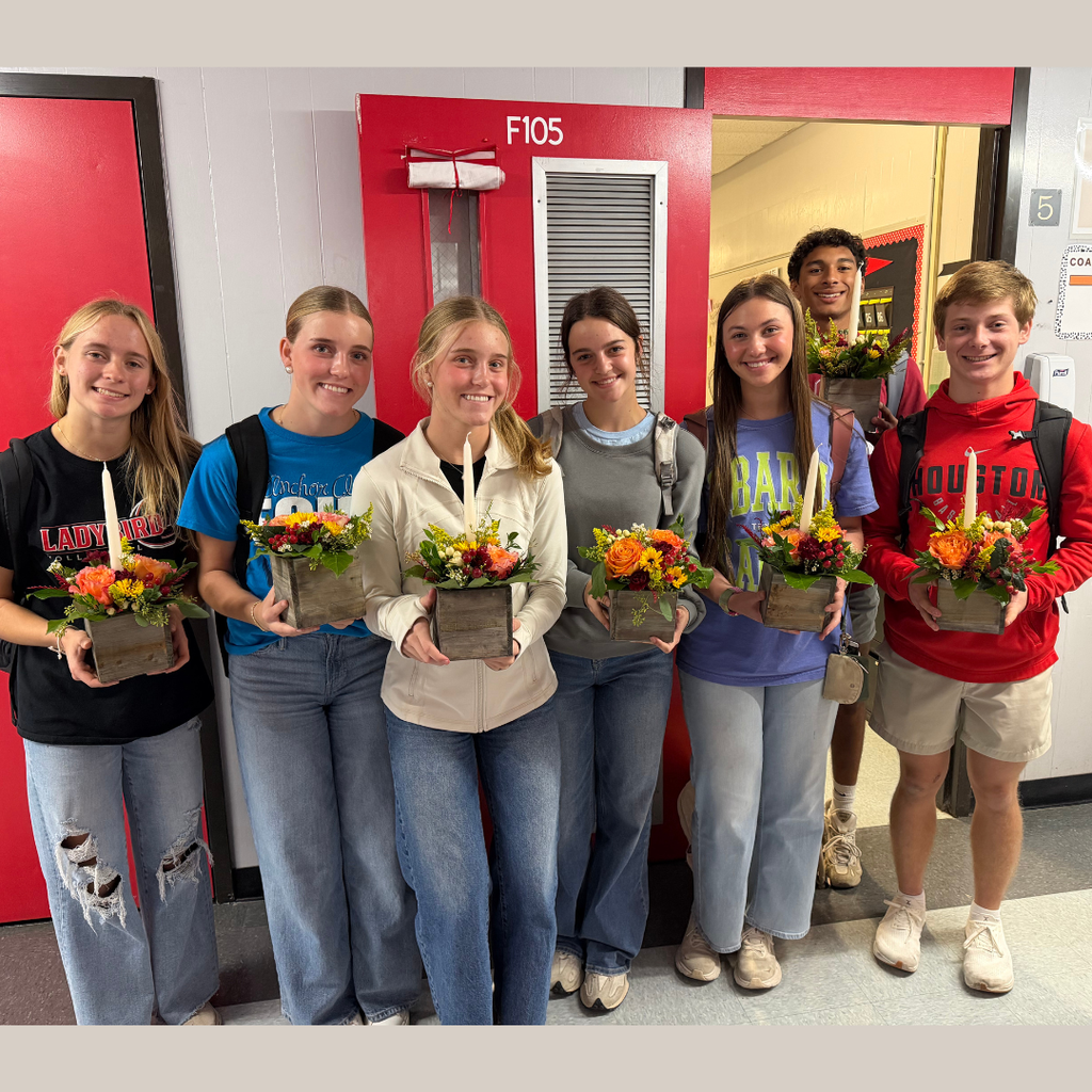 students holding their arrangement 