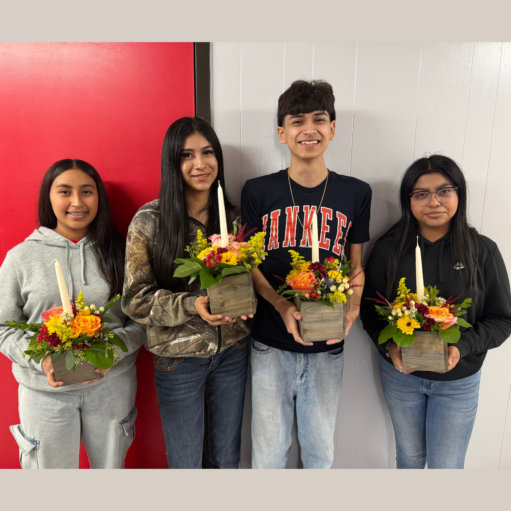 students holding their arrangement 
