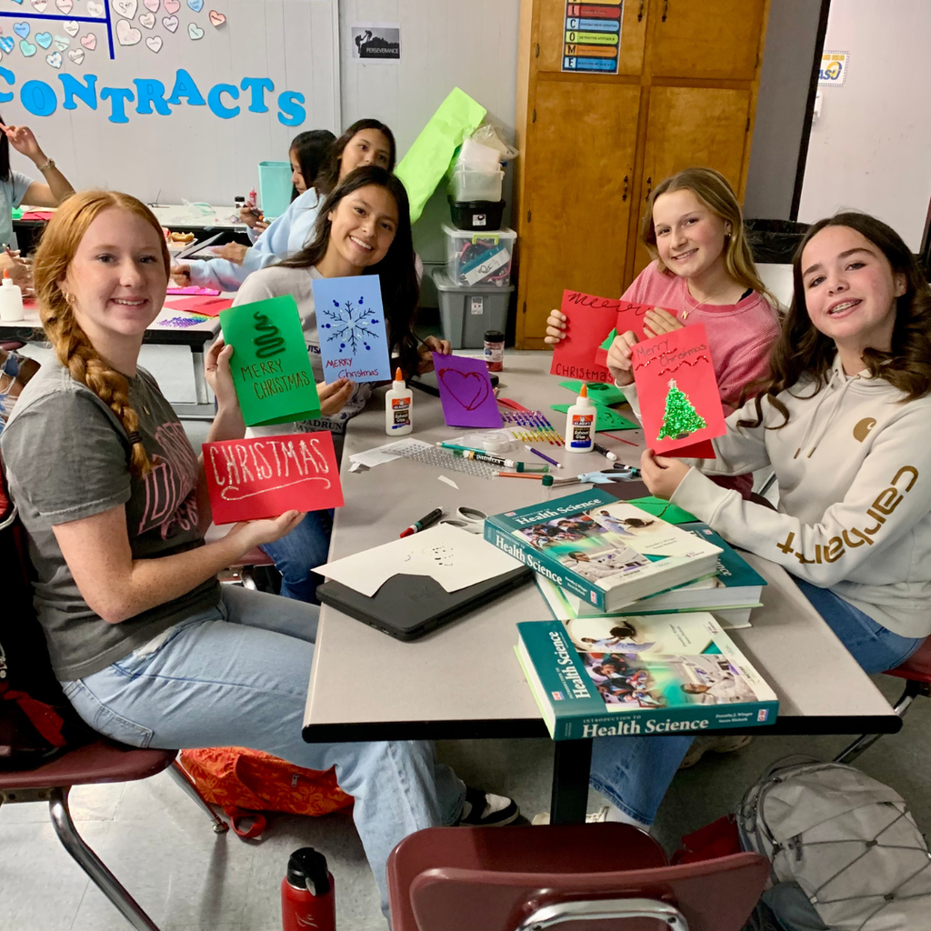 students showing off their holiday cards 