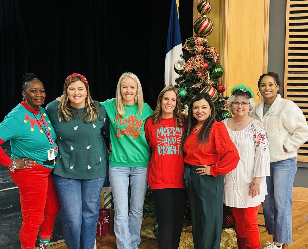 staff around tree in holiday shirts