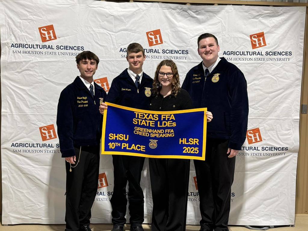zane and coach lowe holding his FFA banner