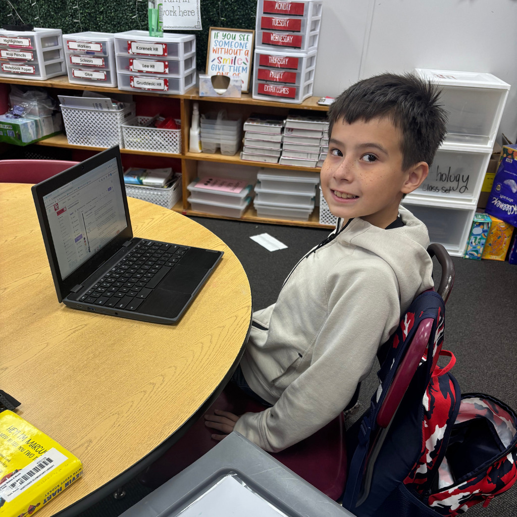 student working on computer at table