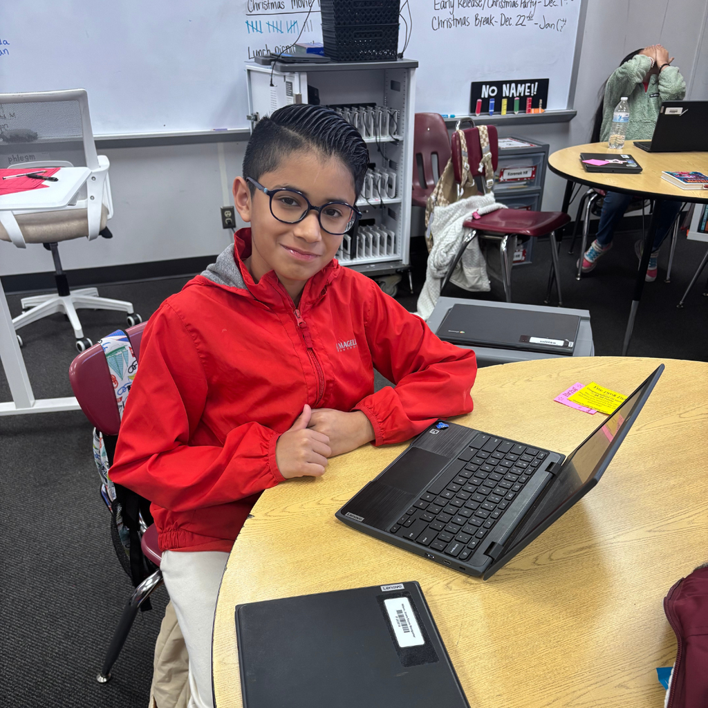 student working on computer at table