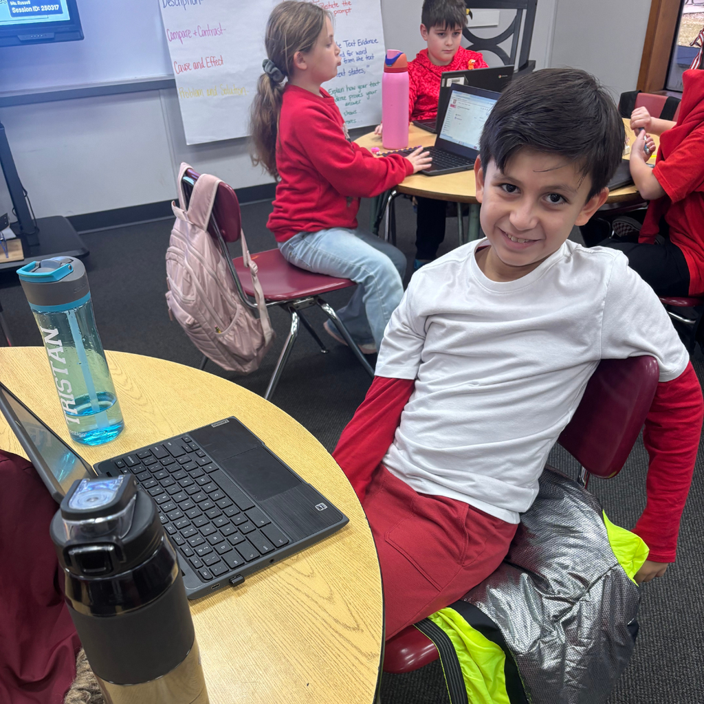 student working on computer at table