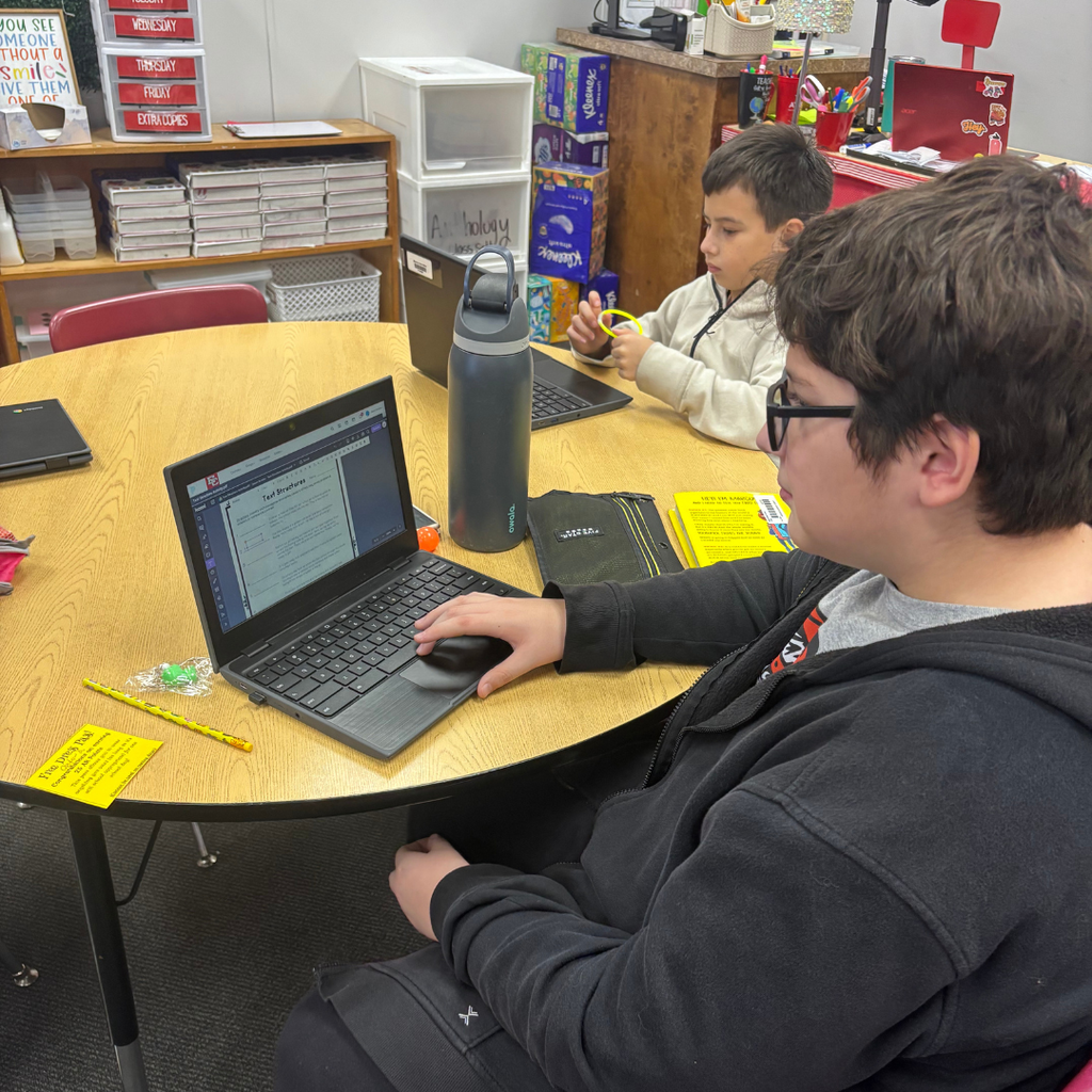 student working on computer at table