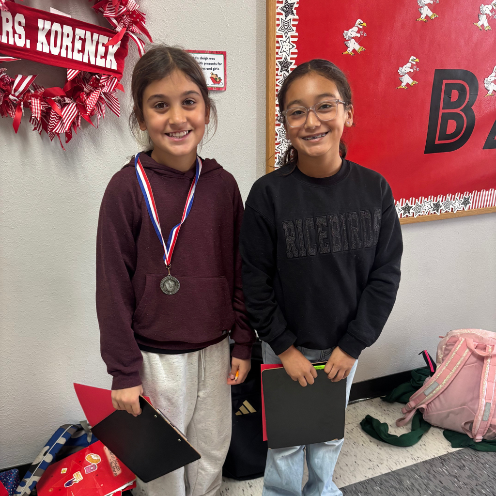 students in hall smiling for the camera