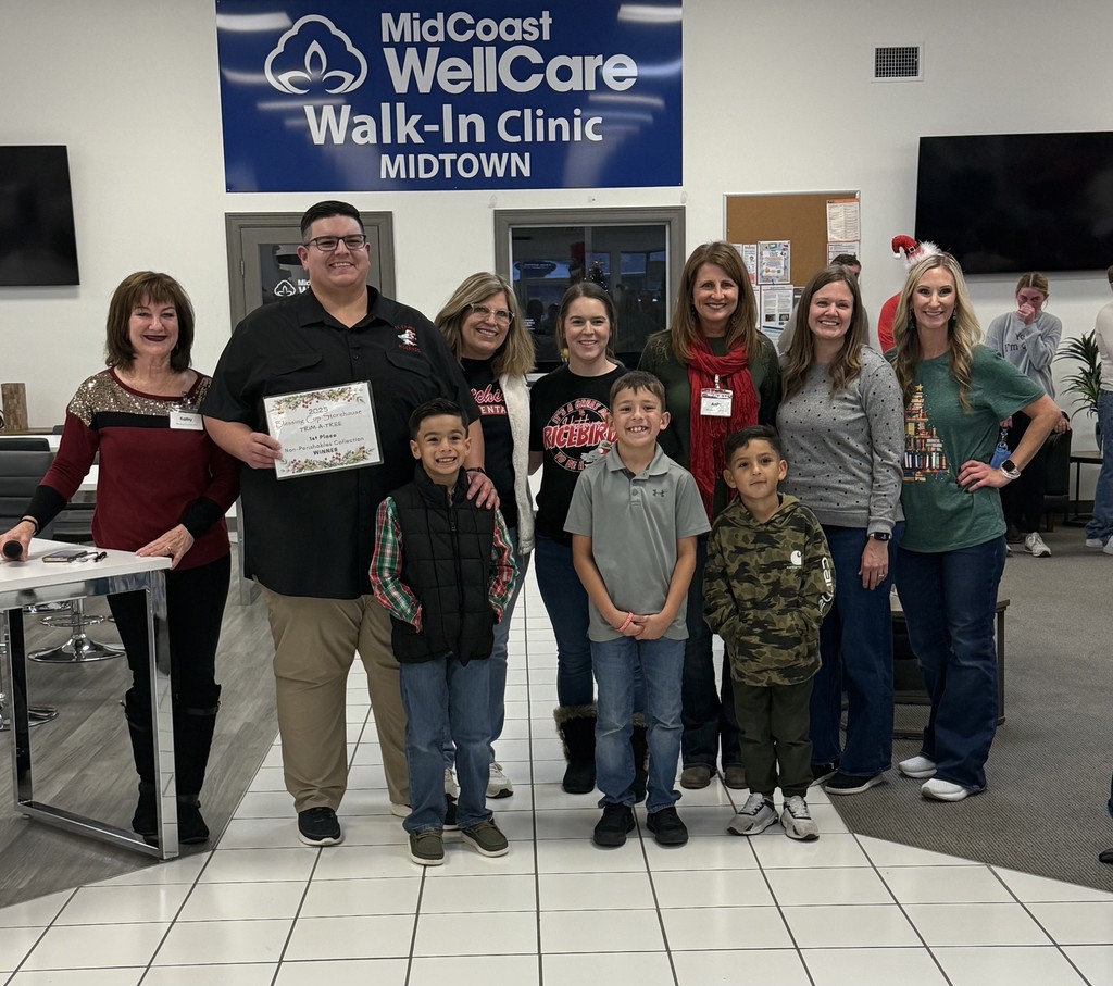 ladies from the blessing cup presenting certificate to principal, teachers, staff, and students of Hutchins