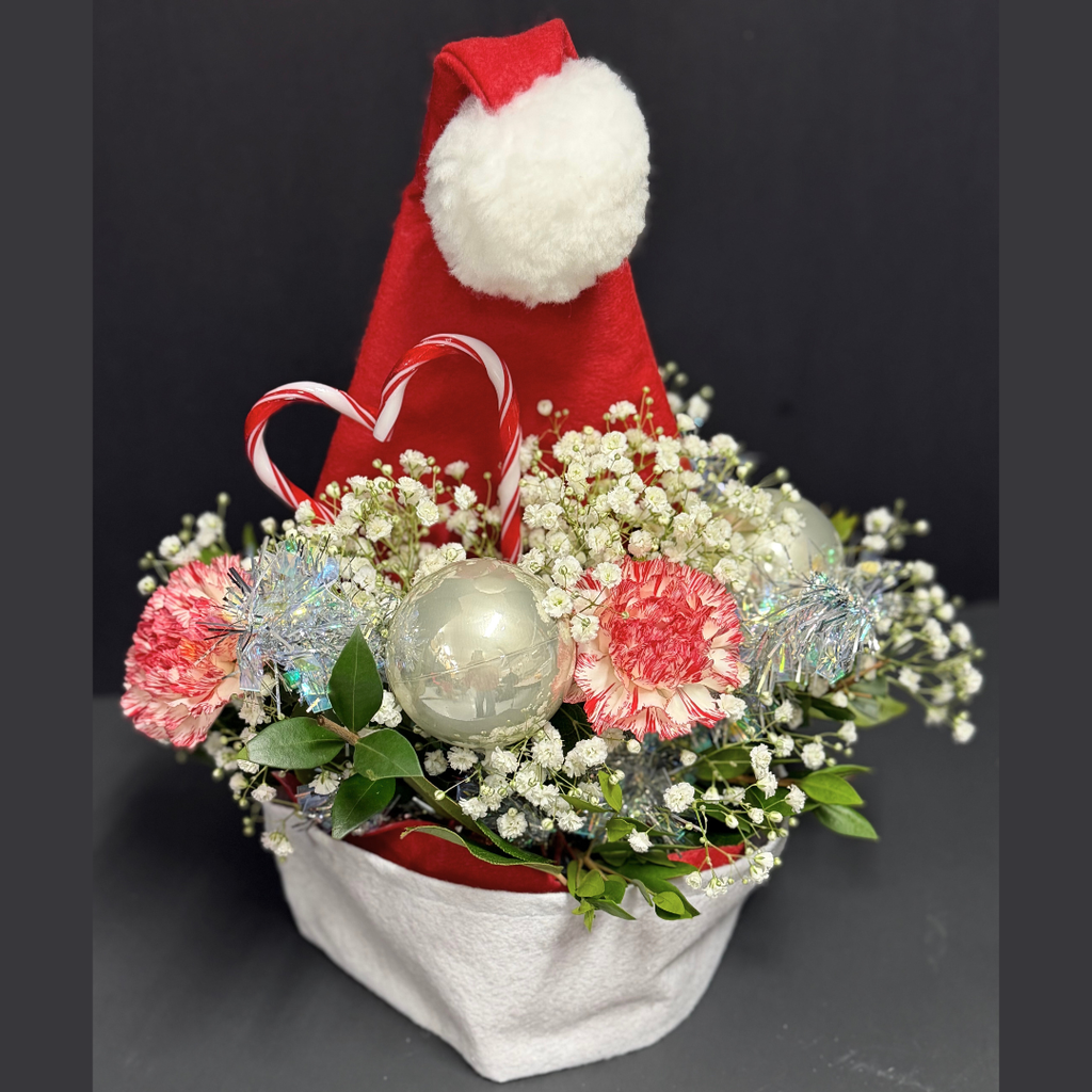 floral arrangement in a santa hat