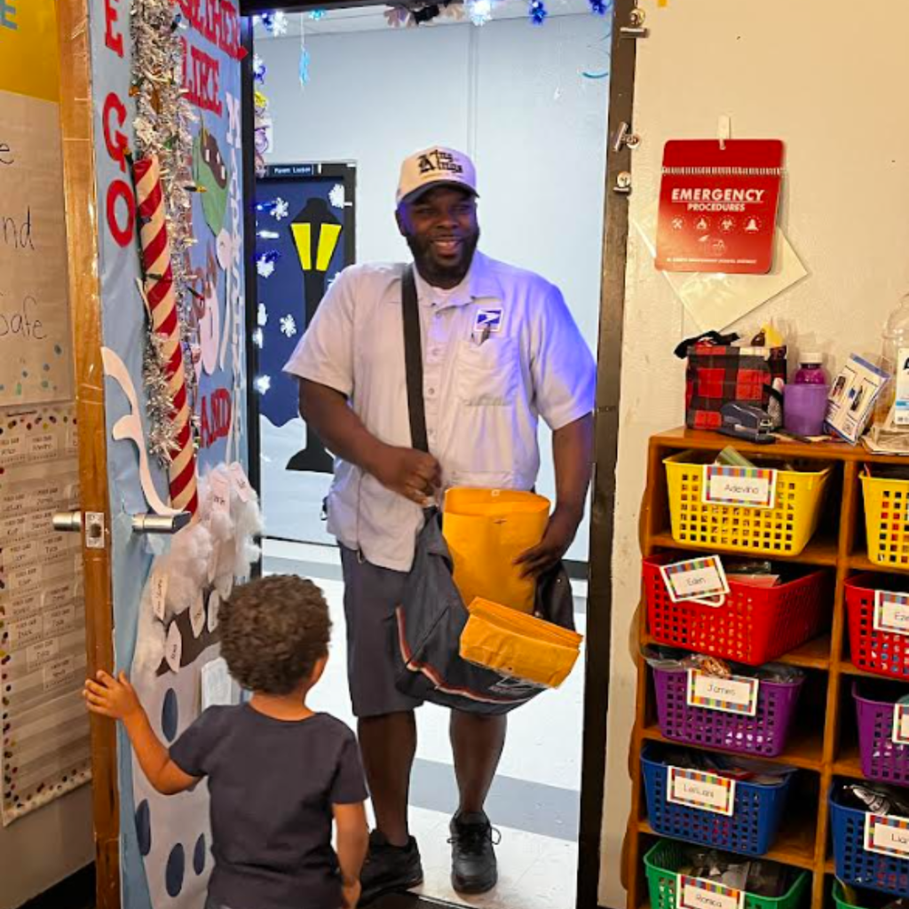 mailman greeted at the door by a young child
