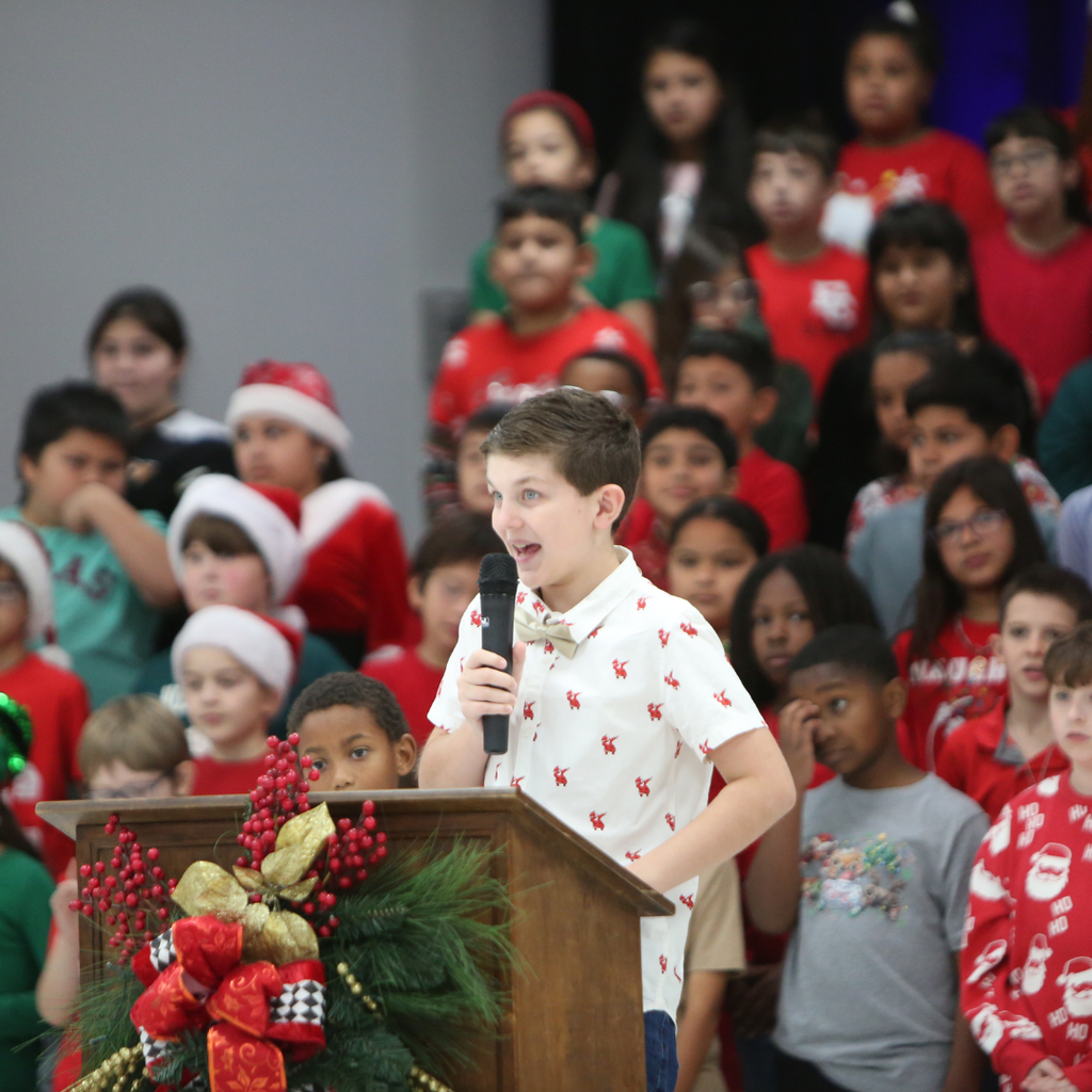 student at podium with microphone at program