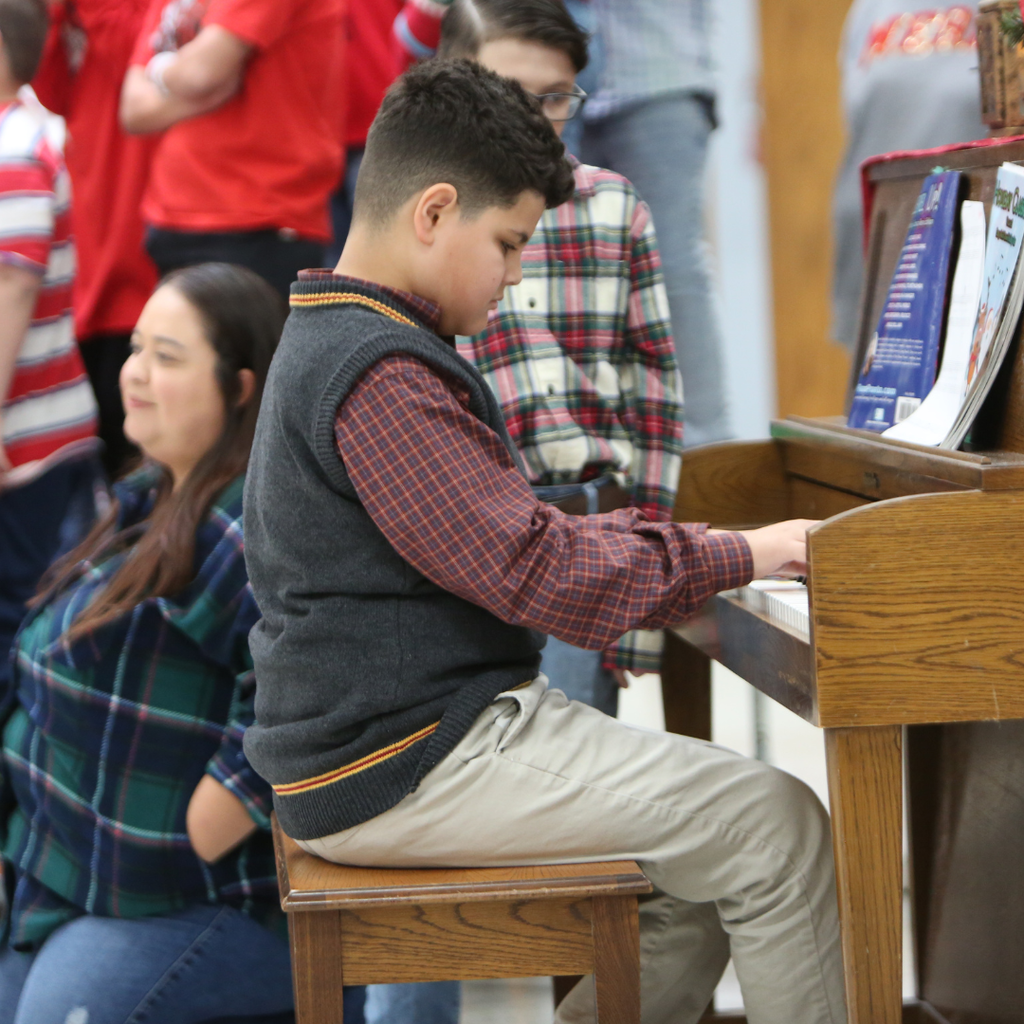 boy playing the piano at program